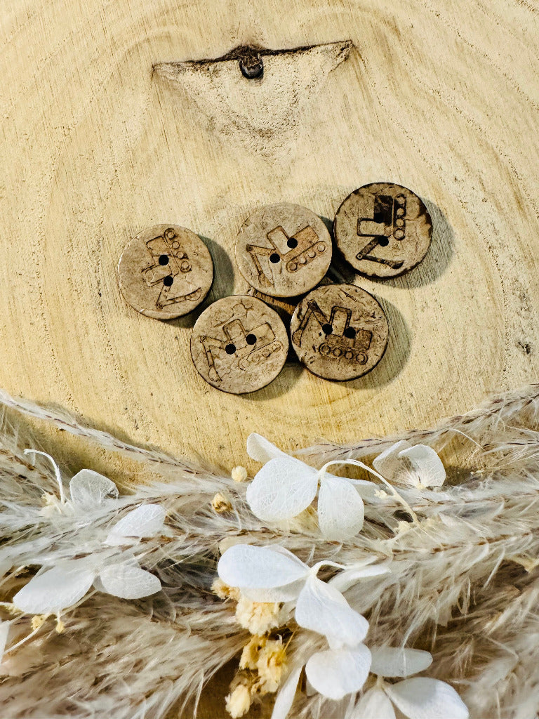 Kokosknopf rund mit einem Bagger abgebildet