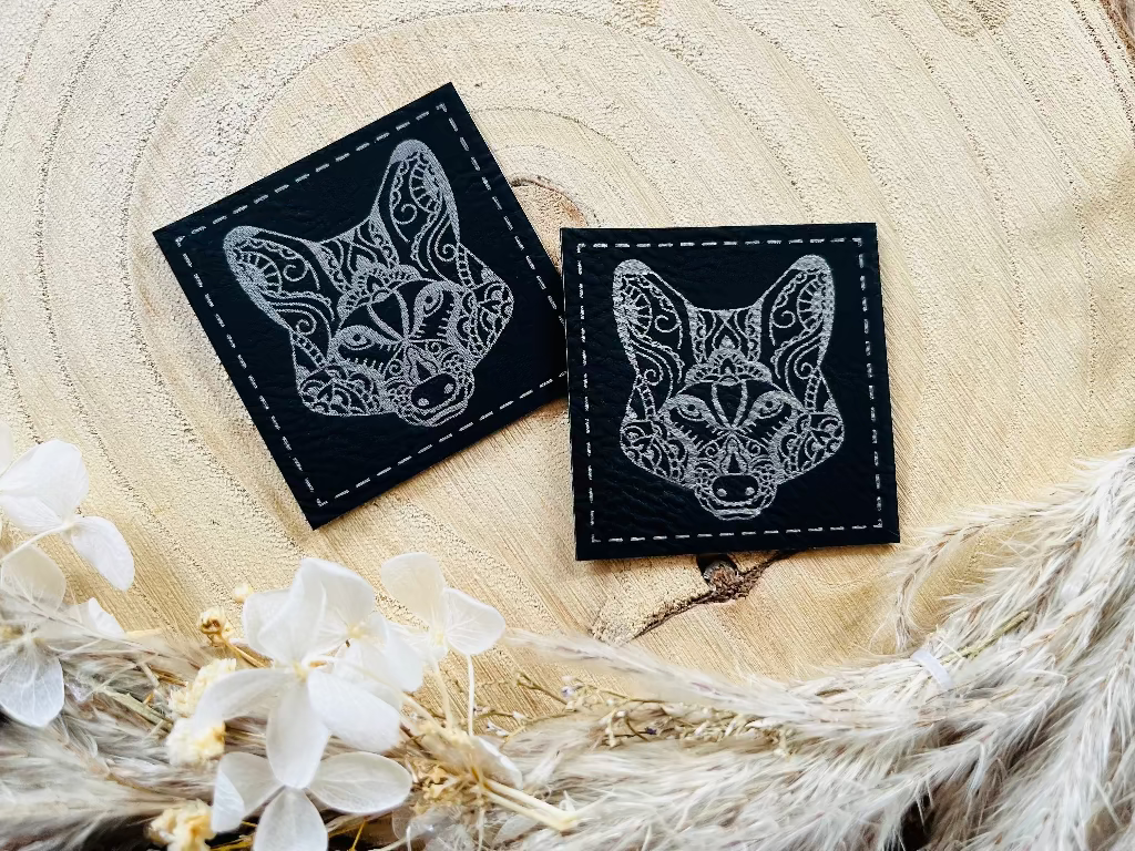 schwarzes kunstlederlabel mit einem wolfs kopf abgebildet