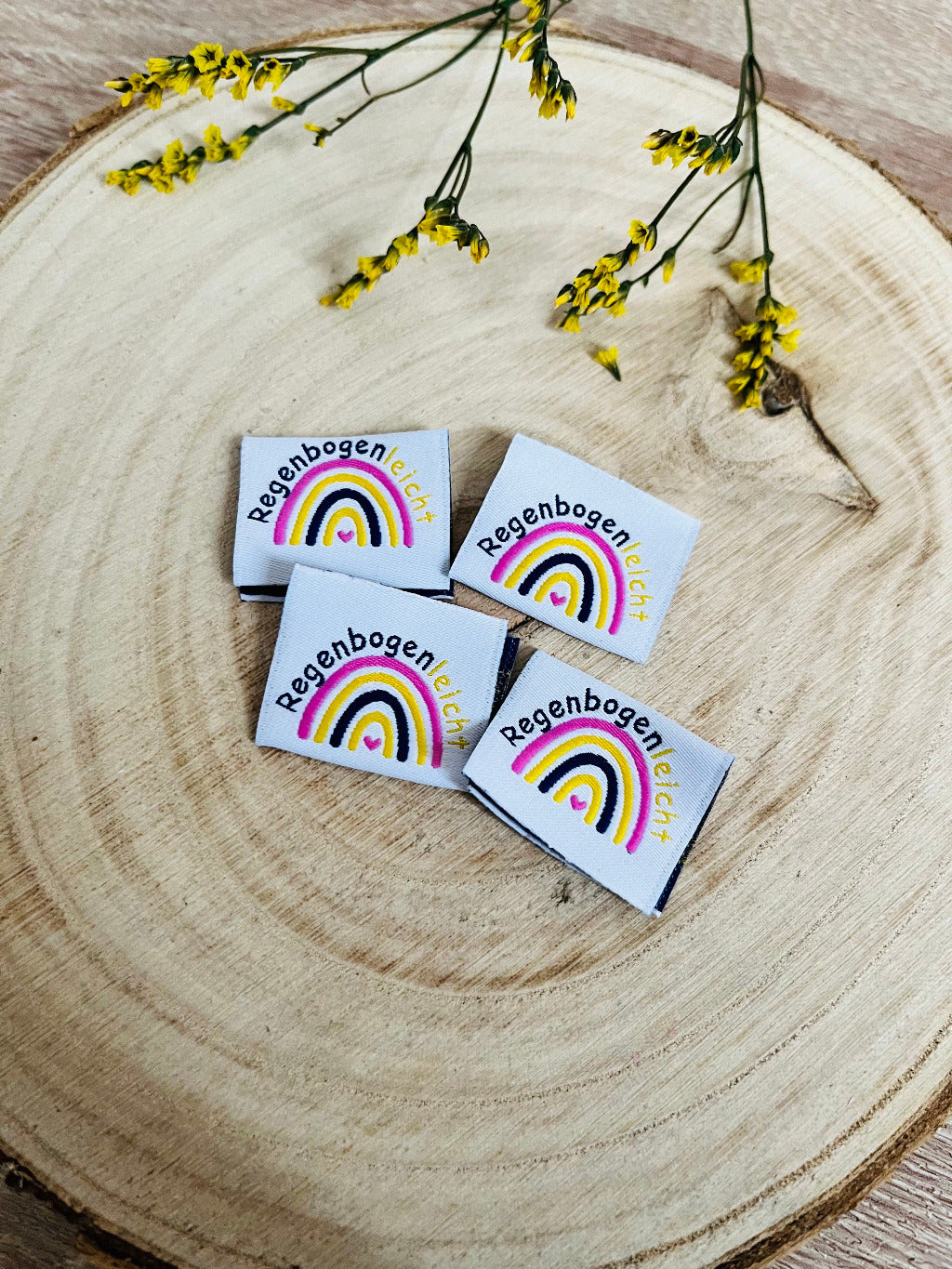 weisses Weblabel mit einem bunten Regenbogen und der gebogenen Überschrift Regenbogenleicht in schwarz gelber Schrift