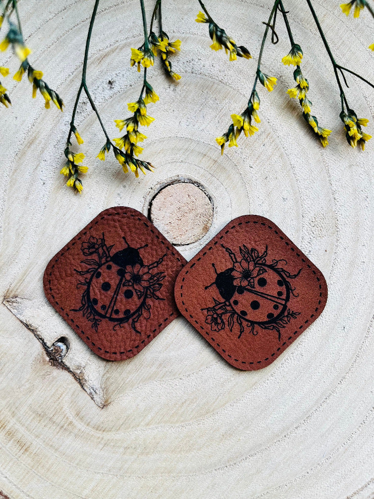 superweiches braunes Kunstlederlabel mit einem kleinen Marienkäfer abgebildet