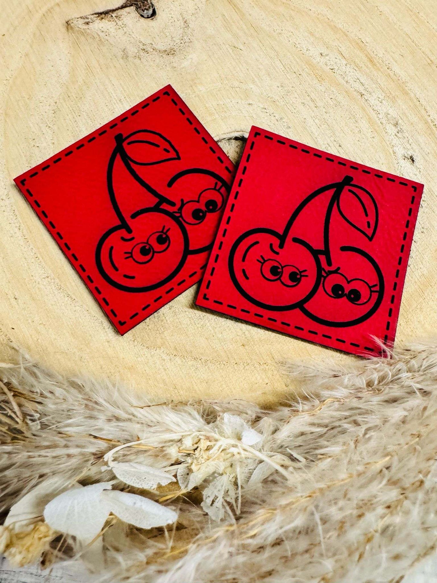 superweiches rotes Kunstlederlabel mit zwei frechen Kirschen abgebildet
