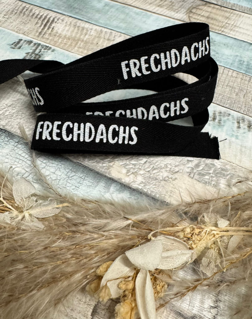 schönes schwarzes Baumwoll Webband mit dem Spruch Frechdachs
