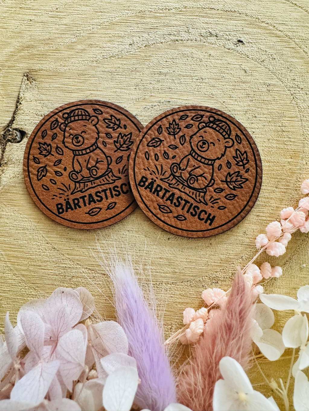superweiches rundes braunes Kunstlederlabel mit dem Spruch Bärtastisch und einem kleinen Bärchen im Blätterwind