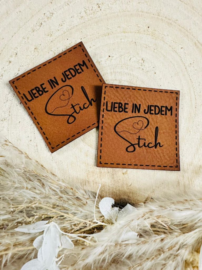 superweiches braunes Kunstlederlabel mit dem Spruch Liebe in jedem Stich in schwarzer Schrift