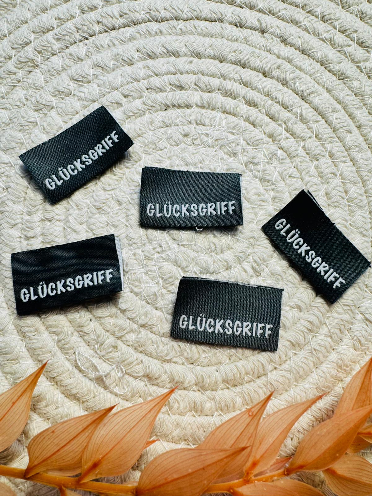 tolles Baumwoll Klapp Weblabel mit dem Spruch Glücksgriff