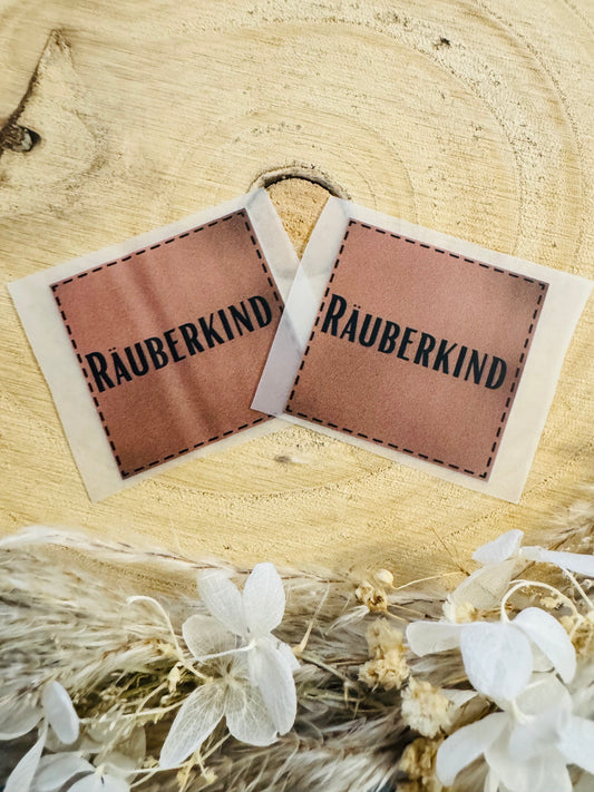 braunes Bügellabel mit dem Spruch Räuberkind in schwarzer Schrift