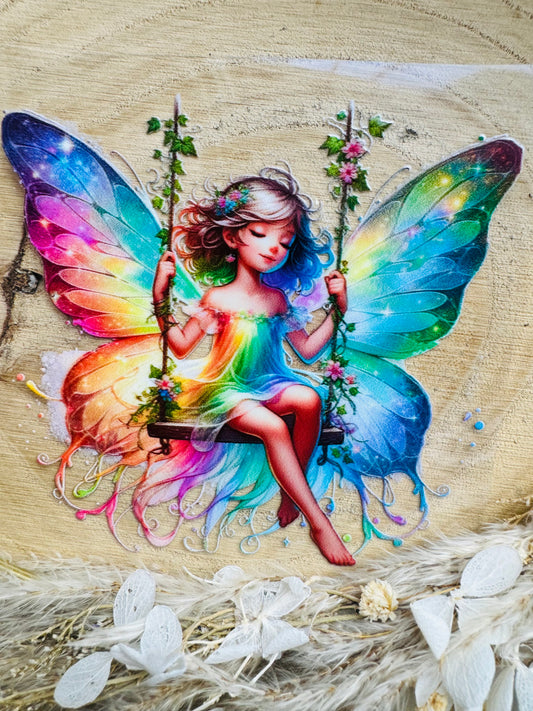 UV-Sticker mit einer kleinen Fee die verträumt auf einer Schaukel schaukelt in bunten Aquarell Farben