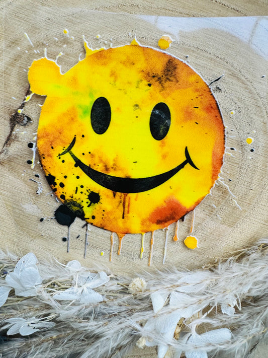 UV-Sticker mit einem lächelndem Smiley in gelben Aquarell Farben