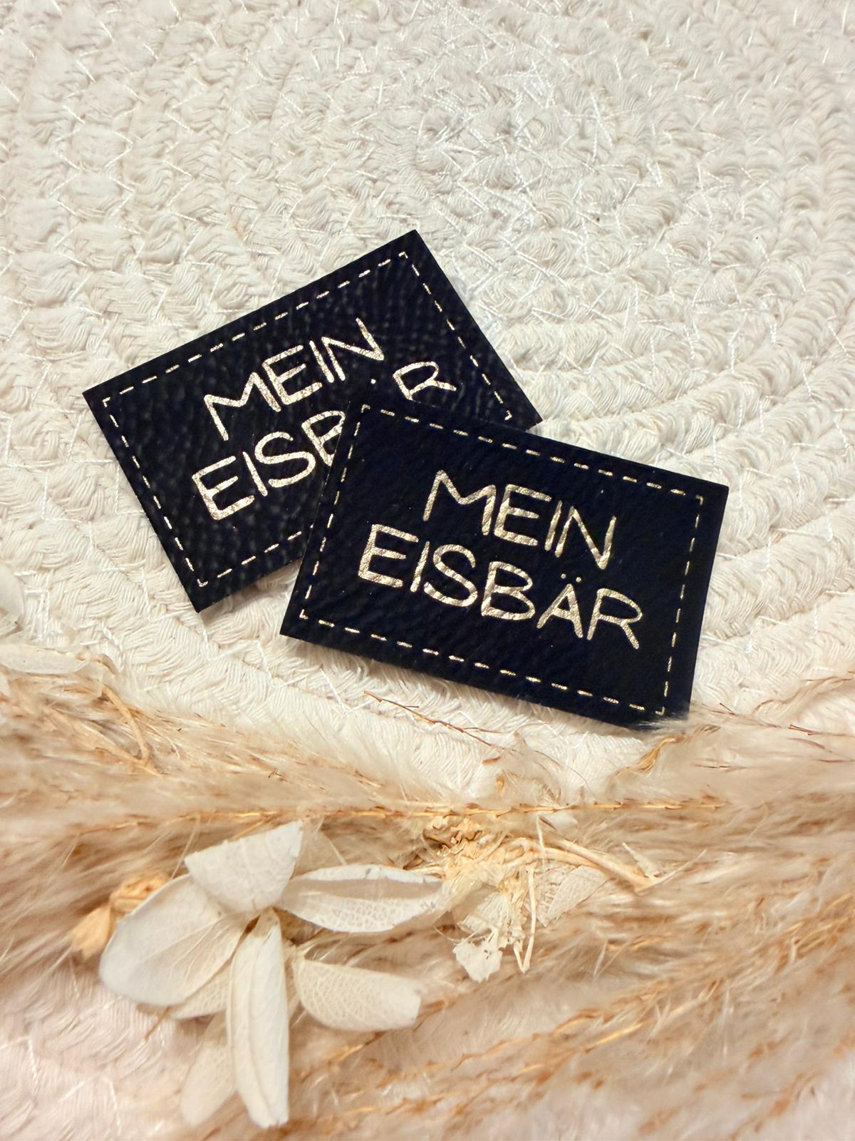 superweiches schwarzes Kunstlederlabel mit dem Spruch Mein Eisbär in goldenen Buchstaben