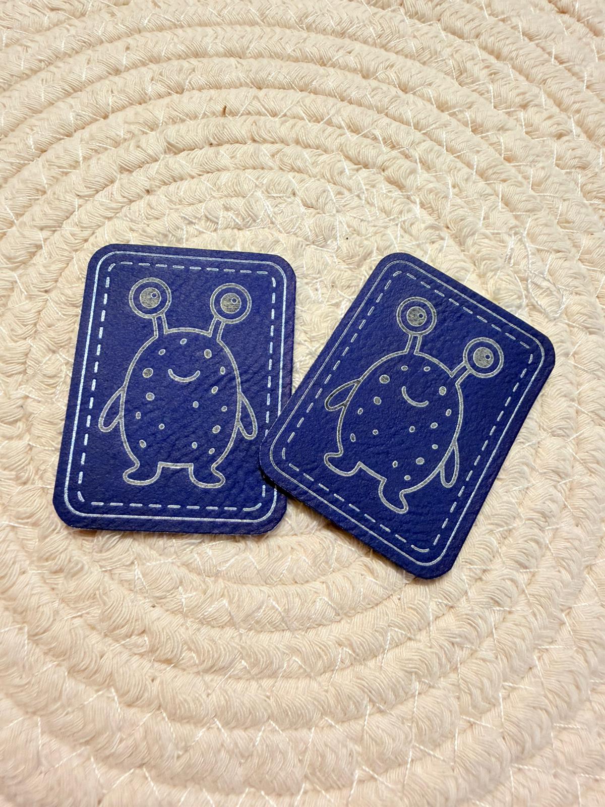 superweiches blaues Kunstlederlabel mit einem kleinen zweiäugigen Monsterchen