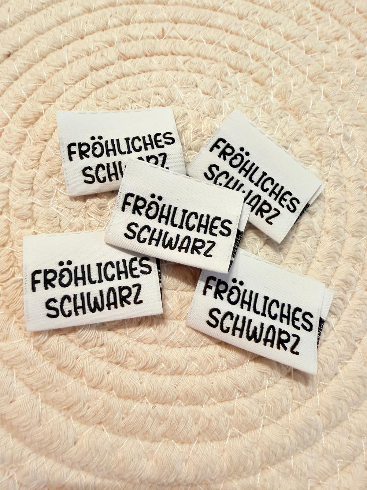 tolles Klapp Weblabel mit dem Spruch Fröhliches Schwarz in schwarzer Schrift auf weissem Untergrund